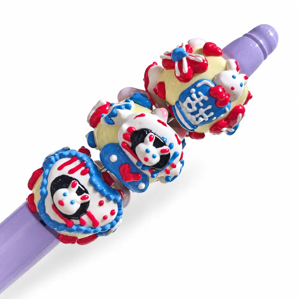Ten hand-painted acrylic beads with lavender bunny designs, pale yellow bases, red hearts and blue flower details.