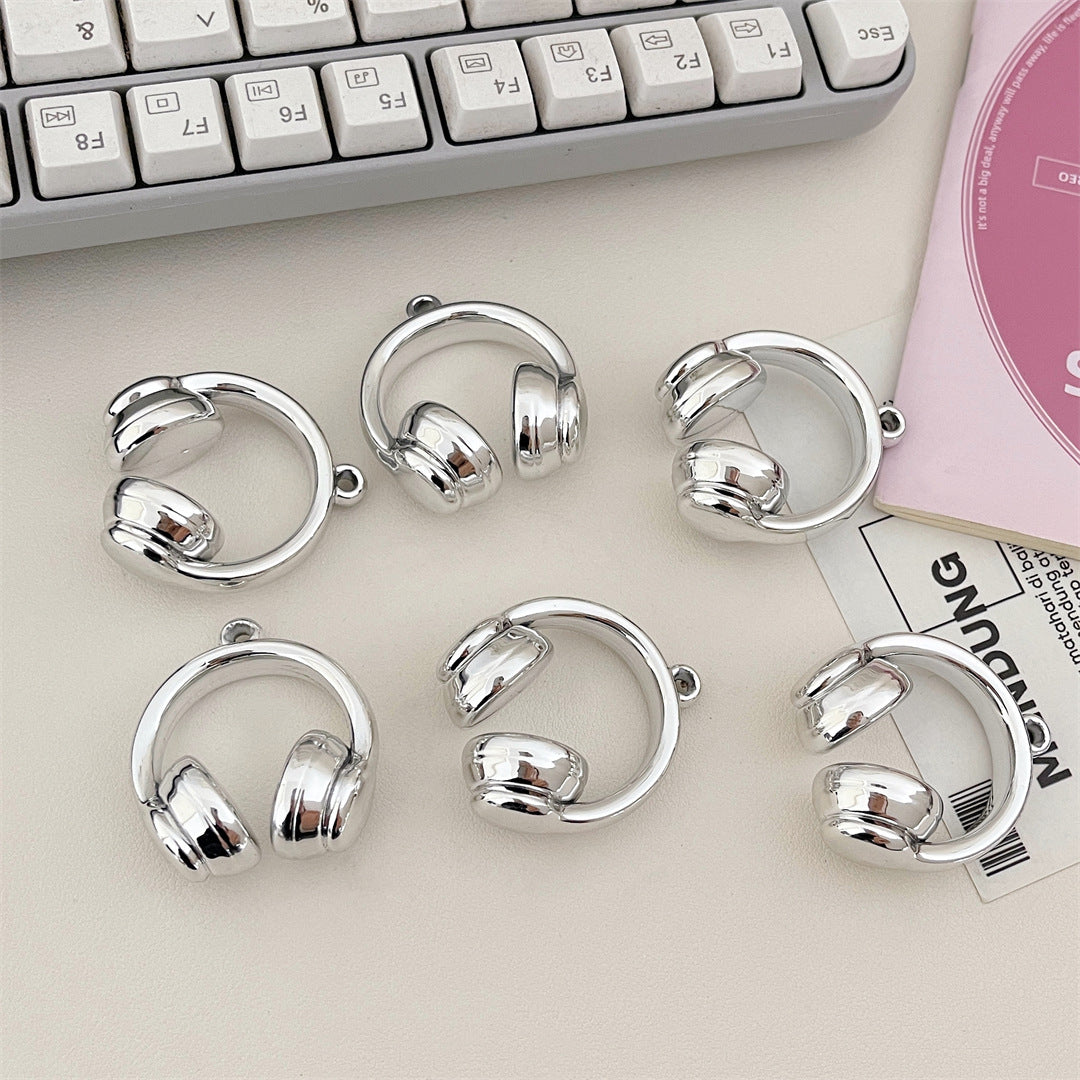 Silver-finish acrylic headphone charms with reflective surfaces and small hanging loops.