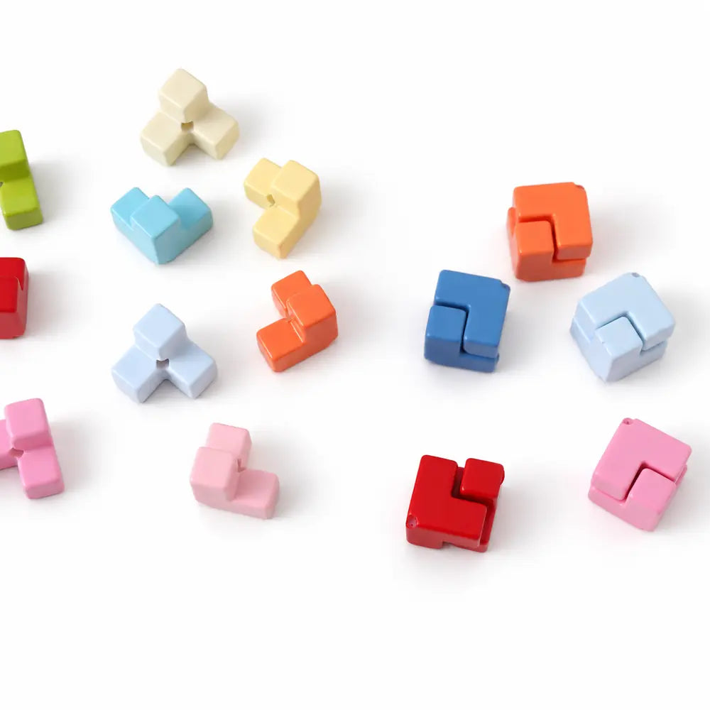 Colorful acrylic puzzle beads with separate pieces and matching pieces fitted together into squares.