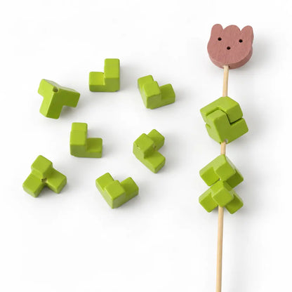 Green acrylic puzzle beads displayed as separate pieces and a joined square on a display rod.