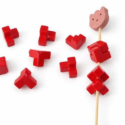 Red acrylic puzzle bead pieces and a matching square assembly showing the interlocking joins.