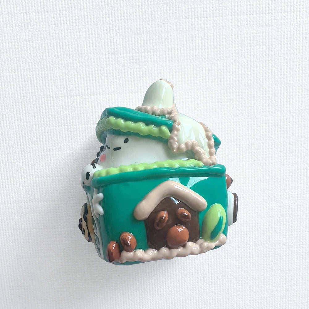 Angled side view of the puppy gift-box bead showing its raised top and side decorations.