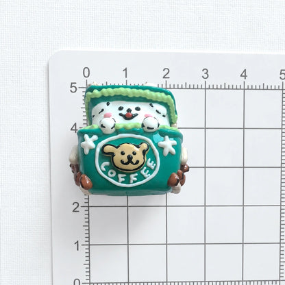Front view of the puppy gift-box bead on a centimeter grid for approximate size reference.