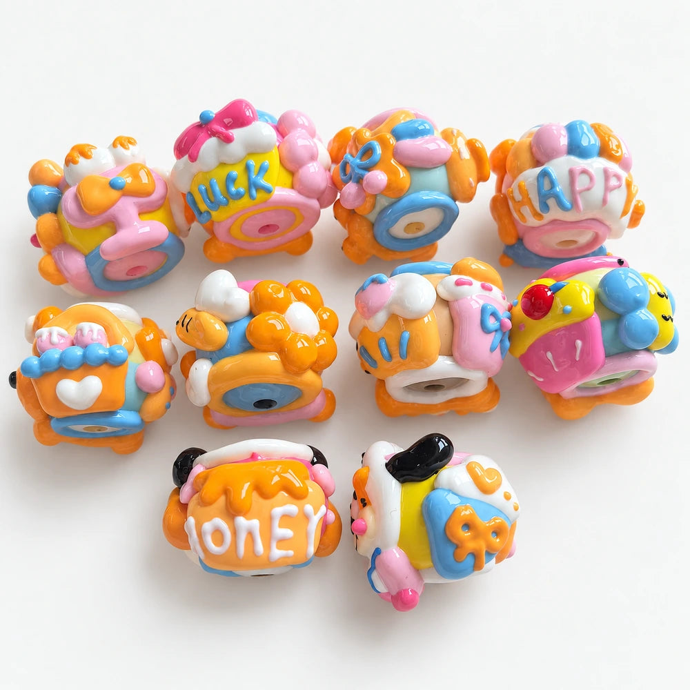 Back view of 10 hand-painted acrylic beads with raised bows, hearts, dessert motifs and colorful lettering.