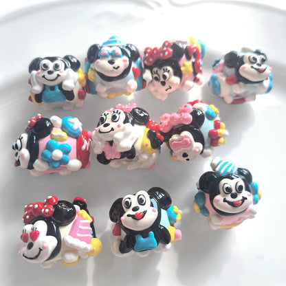 Set of 10 pink and blue hand-painted acrylic beads with black and white faces, bows and raised colorful details.