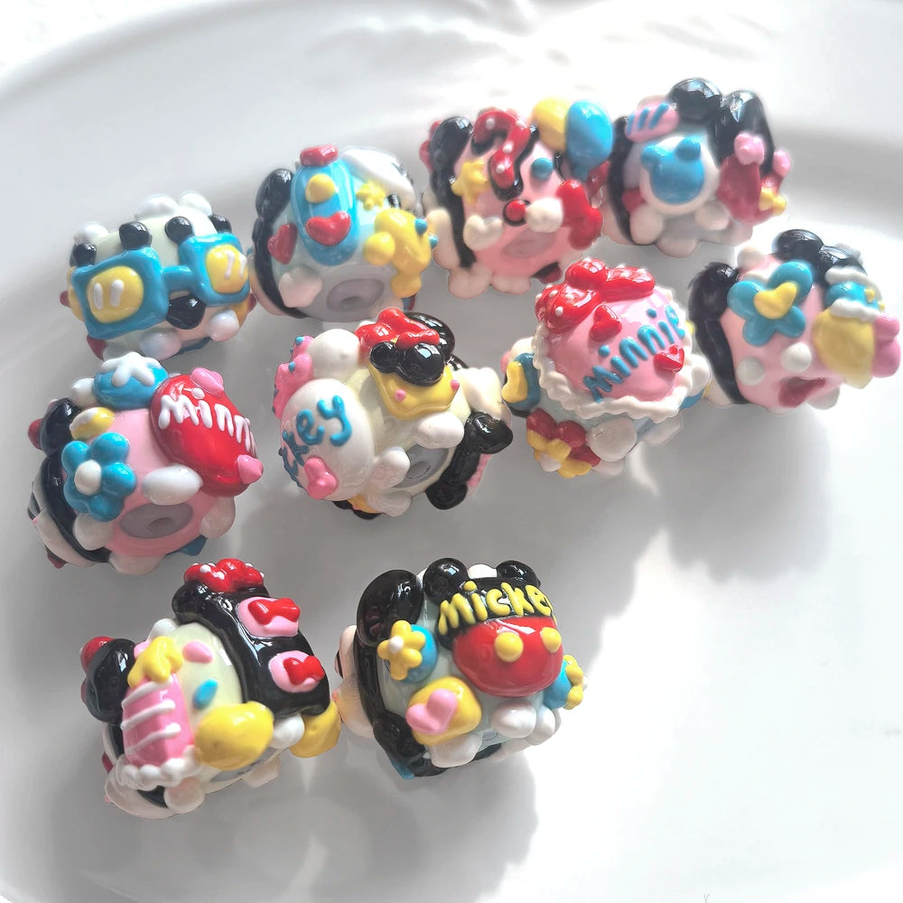 Back view of 10 hand-painted acrylic beads with raised bows, flowers, hearts and decorative lettering.
