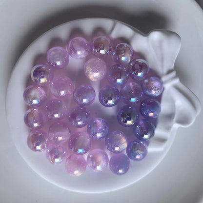 Purple iridescent acrylic round beads with glossy reflections and fine shimmer in a white bow-shaped dish.