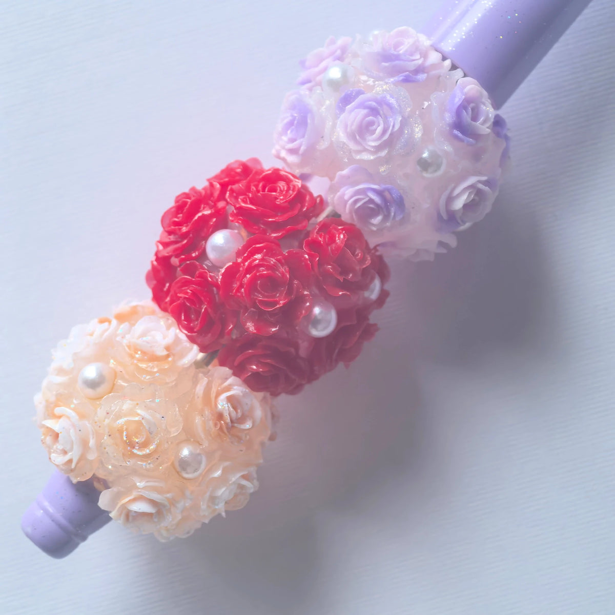 Three rose flower ball beads on a purple beadable pen; the pen is a display example and is not included.