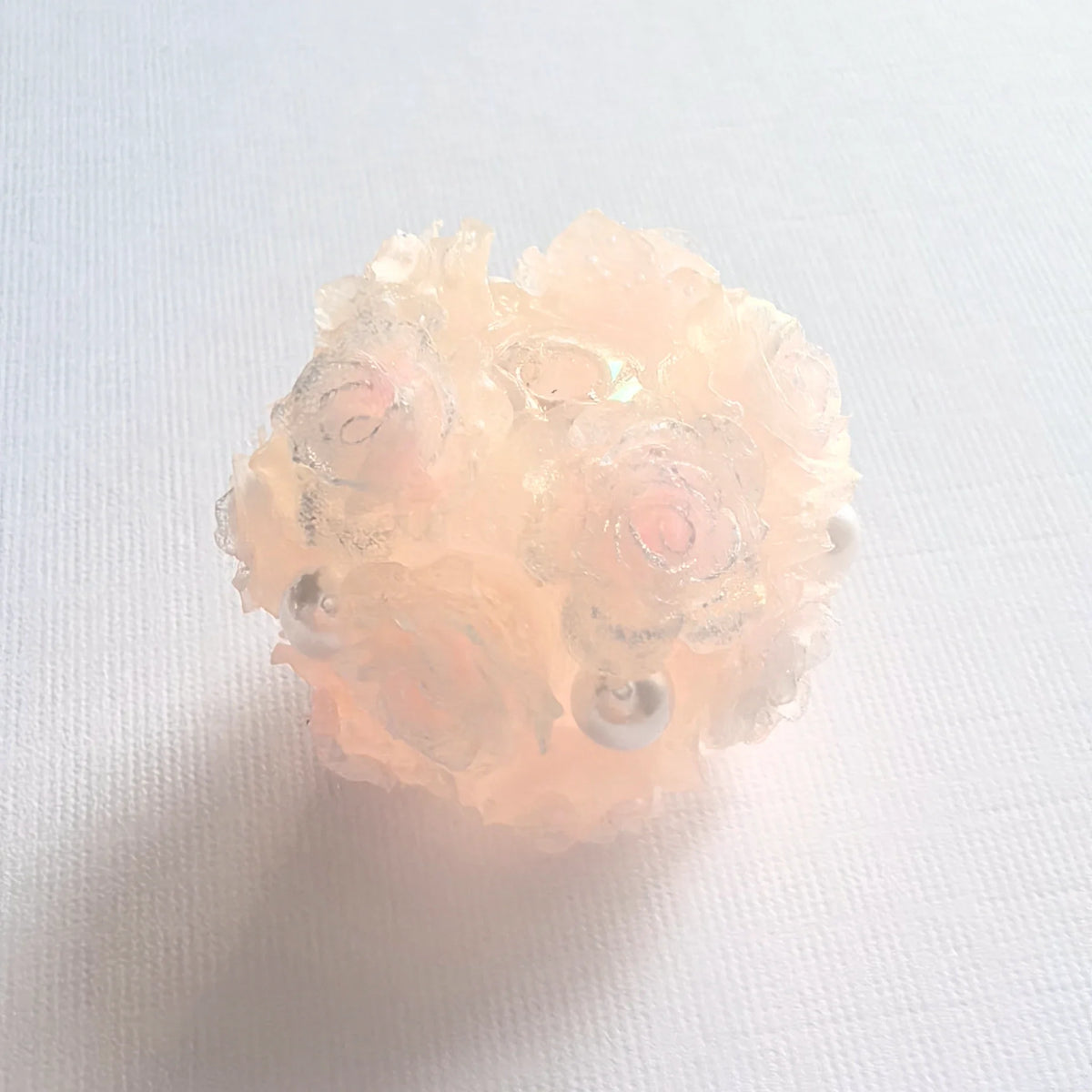 Pink rose flower ball bead with layered rose petals, pearl-like accents and a threading hole.