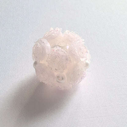 Translucent pink-purple rose flower ball bead with pale pink-lavender petals, pearl-like accents and a threading hole.
