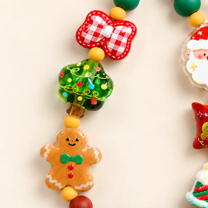 Close-up of the red and white gingham bow, green Christmas tree bead and gingerbread figure with a green bow.