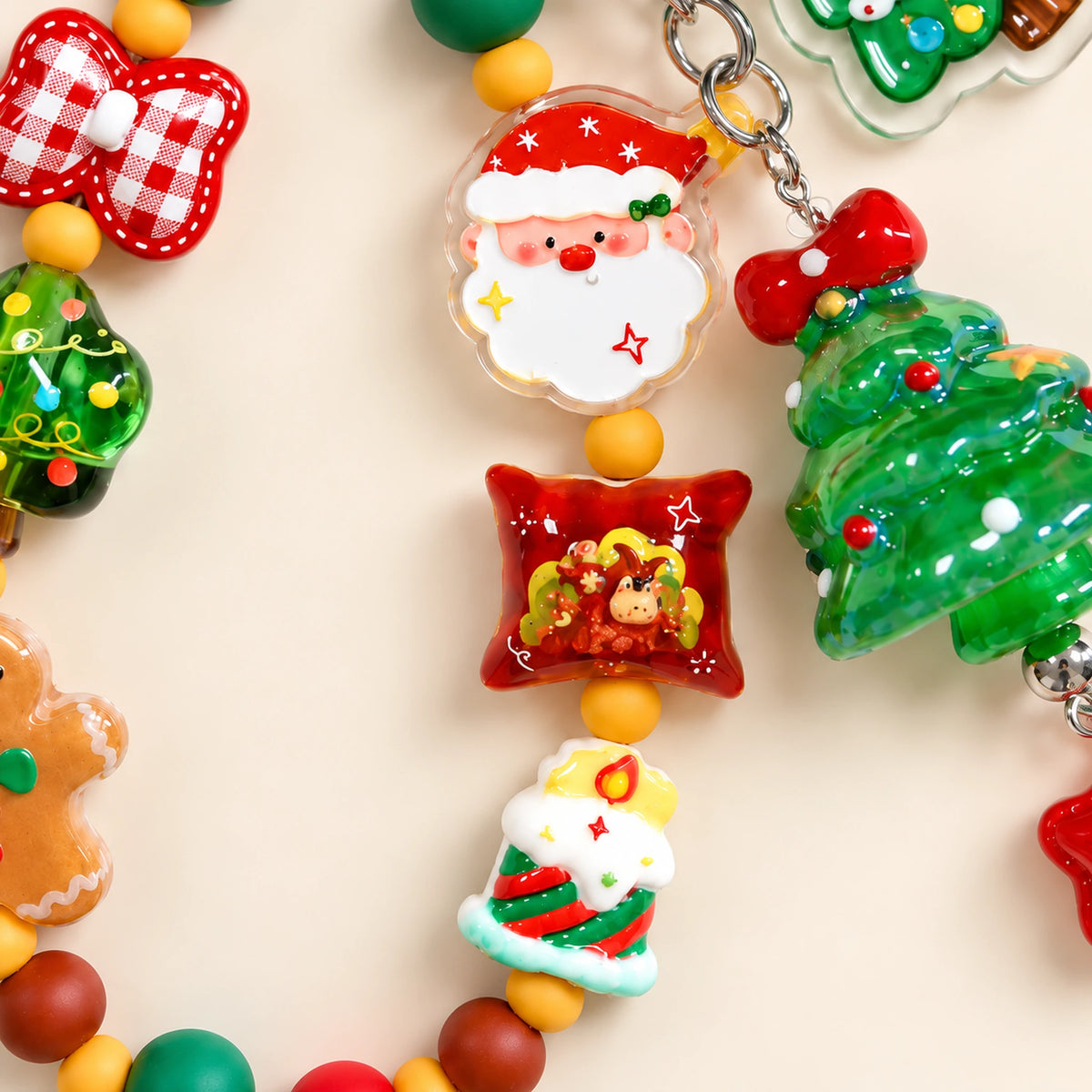 Detail of the Santa face, red pillow-shaped festive bead and striped Christmas candle bead.