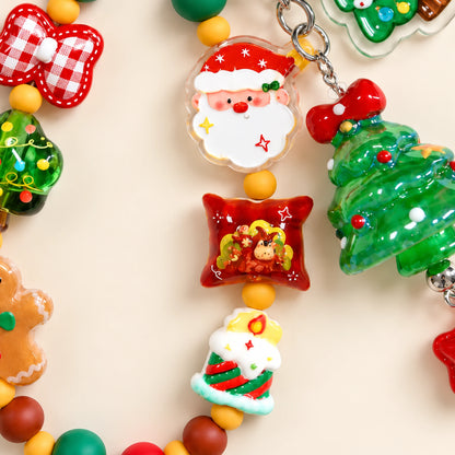 Detail of the Santa face, red pillow-shaped festive bead and striped Christmas candle bead.