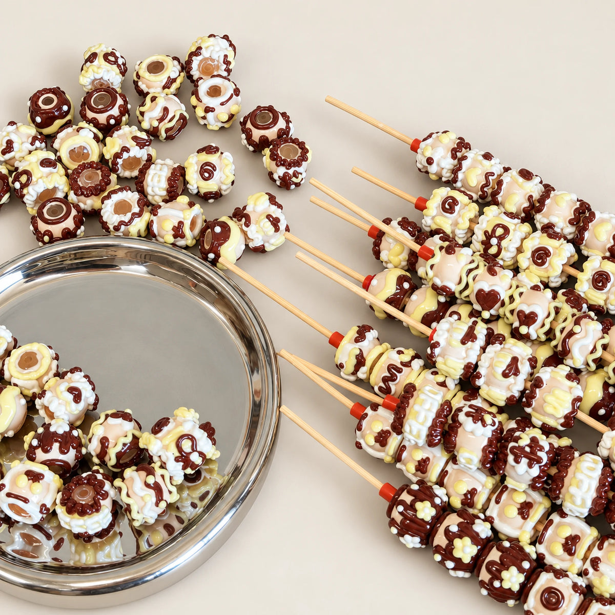 Chocolate color handmade 3D beads threaded onto craft rods to demonstrate hole and decorating details