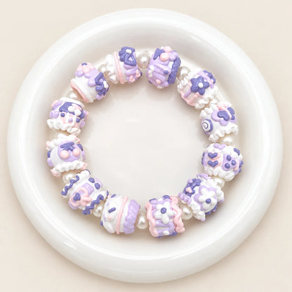 Finished bracelet styling example with lavender-colored handmade 3D beads and pearl-style spacer beads