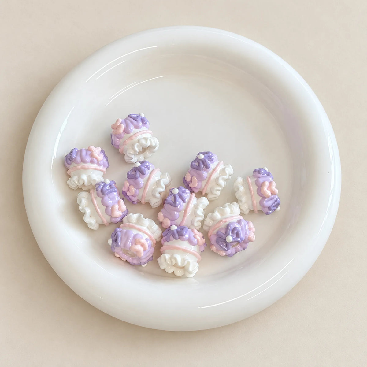 Loose lavender-inspired hand-painted 3D beads showing swirls, flower motifs and white ruffled details