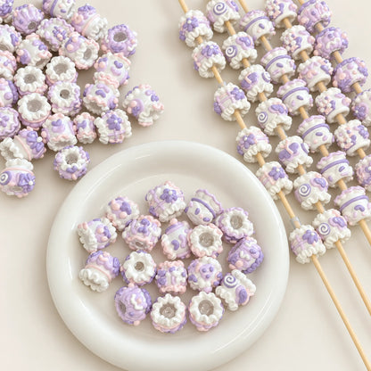 Lavender-inspired pastel purple and white 3D hand-painted beads displayed with craft rods and white bowl