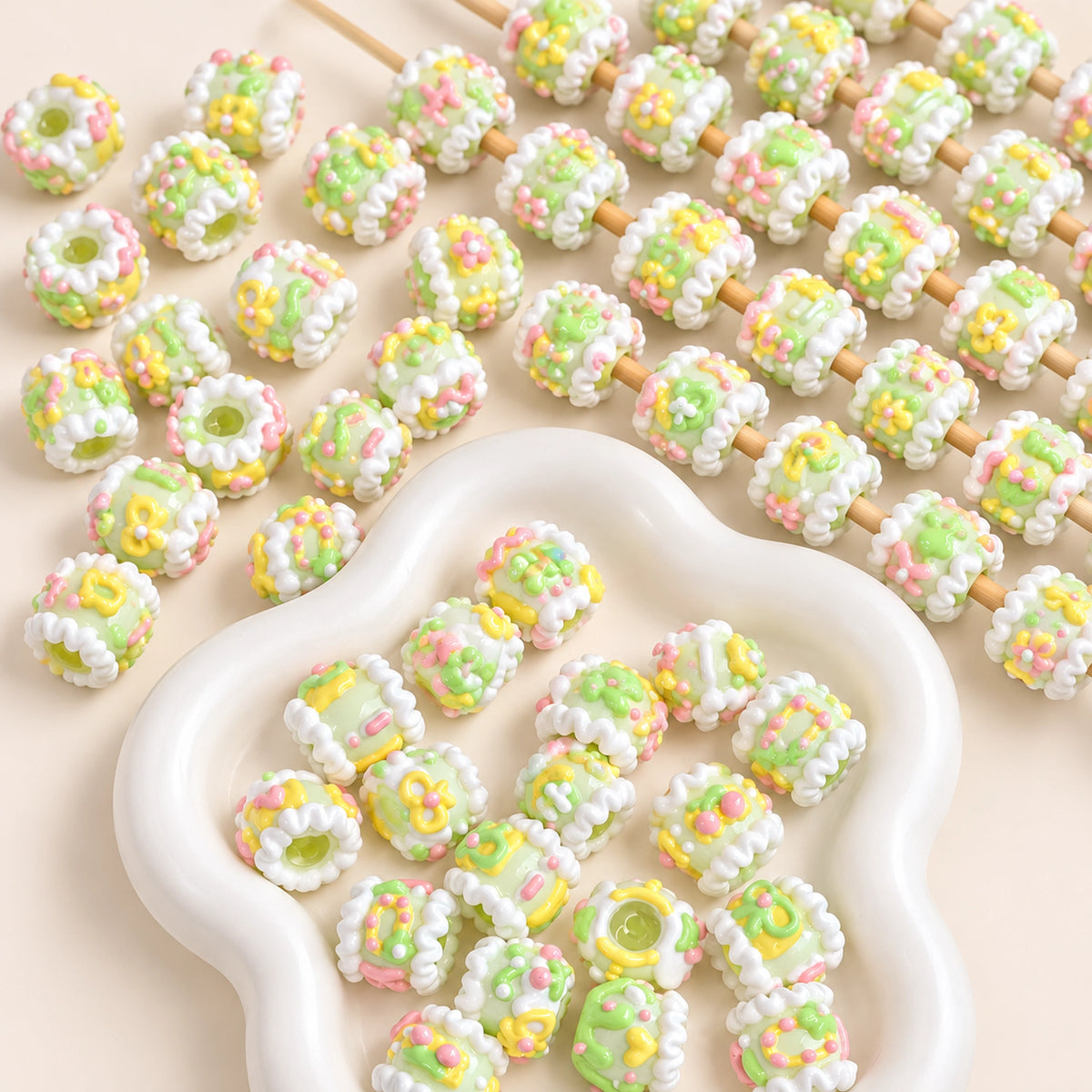Yellow green spring inspired hand-painted 3D beads laid out in a bowl and on craft rods