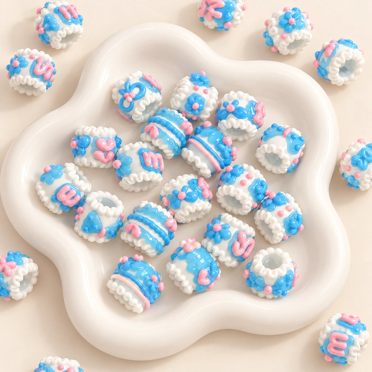 Blue and white jelly finish handmade raised flower beads in a white bowl with soft pink accents