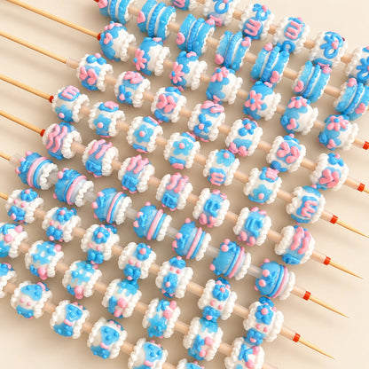 Blue jelly finish 3D handmade beads with white raised trim and pink accents threaded on bead pen rods